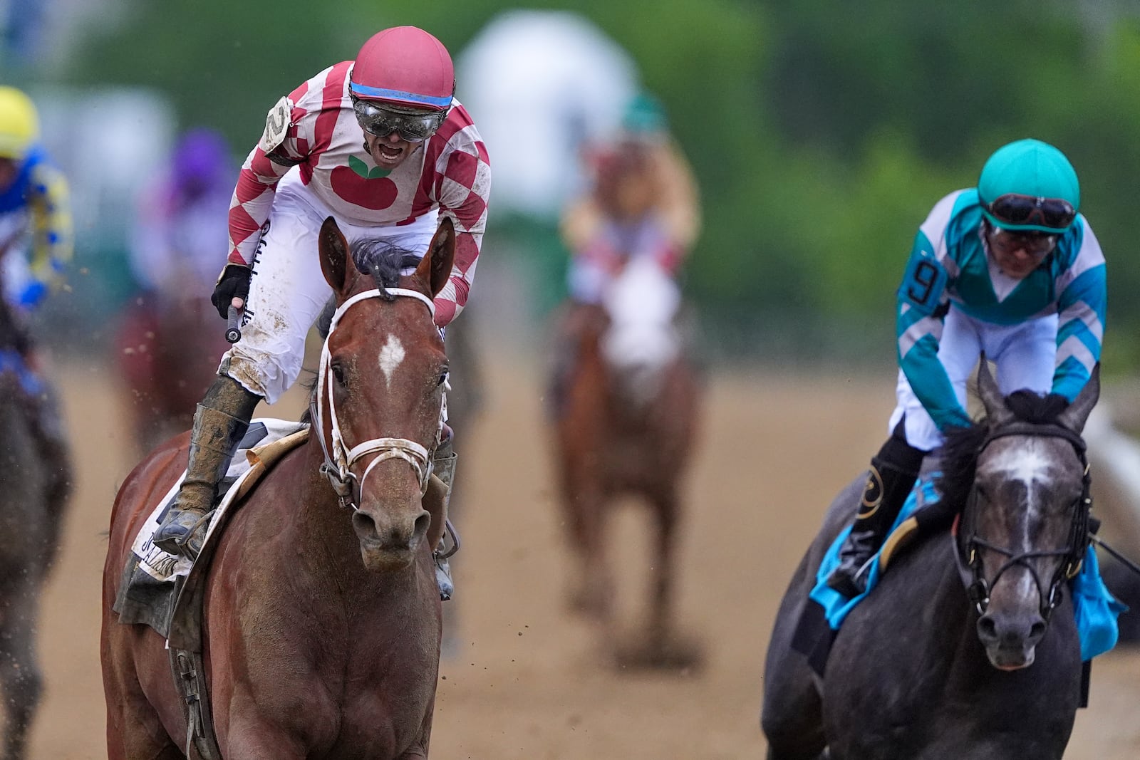 Umberto Rispoli, left, atop Journalism, reacts after edging out Luis Saez, atop Gosger, to win the the 150th running of the Preakness Stakes horse race Saturday, May 17, 2025, at Pimlico Race Course in Baltimore. (AP Photo/Nick Wass)