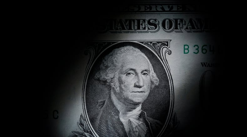 FILE - The likeness of George Washington is seen on a U.S. one dollar bill, March 13, 2023, in Marple Township, Pa. (AP Photo/Matt Slocum, File)