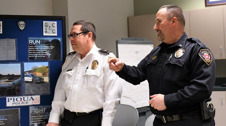 Retiring Piqua Police Chief Bruce Jamison (left) discusses a department recruiting presentation with Lt. Rick Byron, who will be the next chief of the Miami County city. (Contributed)