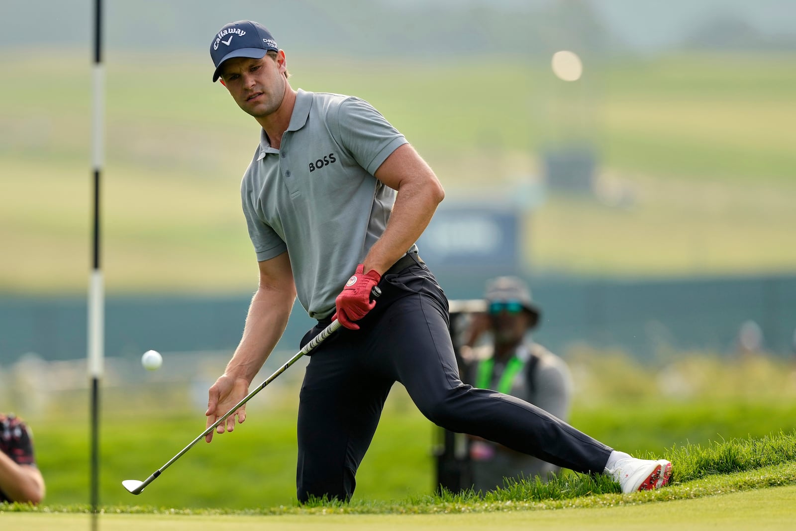Thomas Detry, of Belgium, chips onto the fourth green during the second round of the U.S. Open golf tournament at Oakmont Country Club Friday, June 13, 2025, in Oakmont, Pa. (AP Photo/Carolyn Kaster)