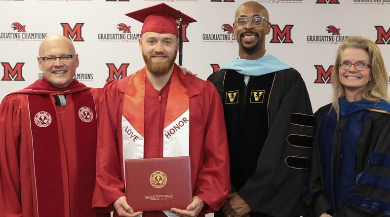 Major League pitcher Sam Bachman holds the degree he was awarded by Miami University Saturday. The Los Angeles Angels first-round pick in 2021 is seen here with Miami President Gregory Crawford, University Ambassador Dr. Renate Crawford, and Ande Durojaiye, dean of the College of Liberal Arts and Applied Science. CONTRIBUTED