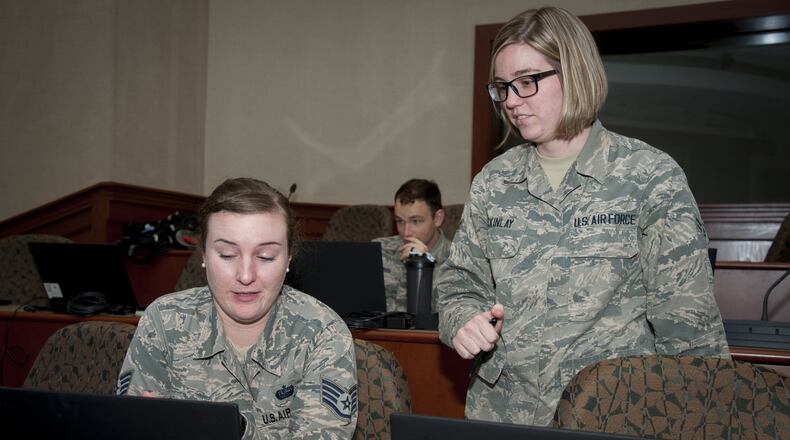 Staff Sgt. Amanda Morgan, Cybersecurity Foundry Course student, receives assistance from Airman 1st Class Shelby McKinlay, a CFC instructor, at MacDill Air Force Base, Fla., March 9. Course instructors taught 100 cyberspace students various cybersecurity functions, processes, procedures and data analysis skills to further their ability to secure the Air Force Network. (U.S. Air Force photo/Senior Airman Mariette Adams)