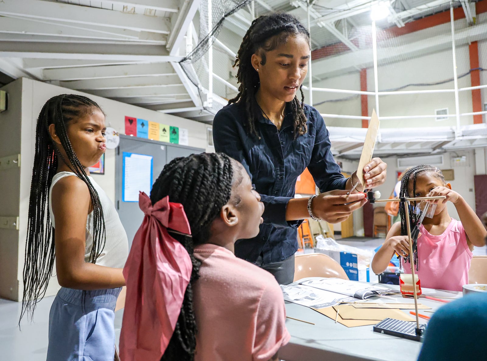 Students in Fail Me Not Tutoring work on a windmill project under the guidance of counselor Adrienne Drake (center) on Wednesday, July 23 at the summer camp, which was held at Trotwood Preparatory and Fitness Academy property. BRYANT BILLING / STAFF