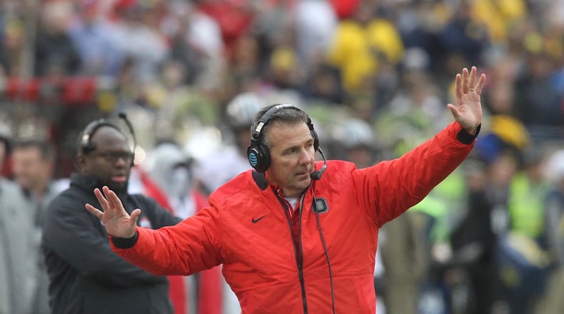 Ohio State’s Urban Meyer talks to his players during a game against Michigan on Saturday, Nov. 25, 2017, at Michigan Stadium in Ann Arbor, Mich. David Jablonski/Staff