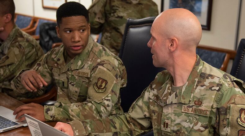 Capt. Josh Cissell (right), an F-22 contracting officer with the Air Force Life Cycle Management Center, talks with 1st Lt. Anthony Bilal, AFLCMC contract specialist, during the joint force contracting exercise June 24 at Wright-Patterson Air Force Base. More than 90 personnel from WPAFB and other installations such as Fort Hood, Texas; Shaw AFB, South Carolina; Fort Bragg, North Carolina; and Joint Base San Antonio, Texas, were involved in the planning, evaluation and execution. U.S. AIR FORCE PHOTO/WESLEY FARNSWORTH