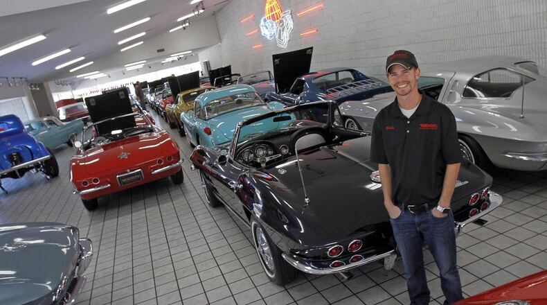 Shelby Mershon, surrounded by classic Corvettes, stands in the showroom of Mershon’s World of Cars in Springfield. © 2018 Photograph by Skip Peterson