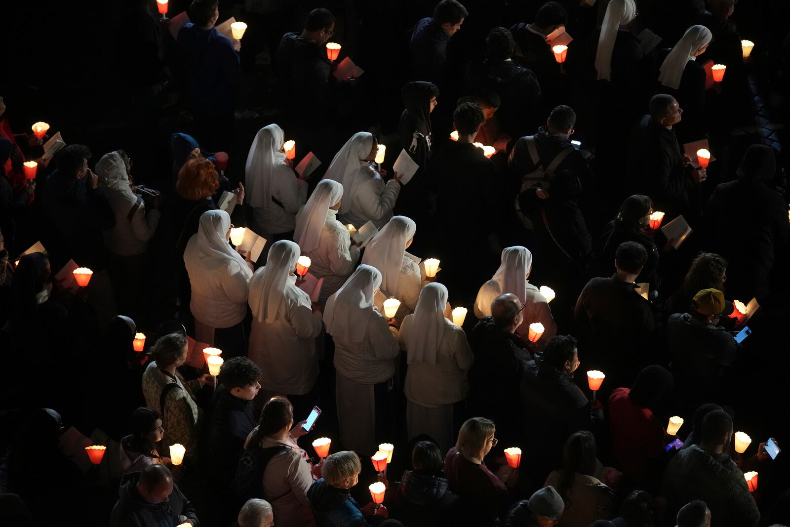 Nuns attend the procession outside the Colosseum during the Via Crucis (Latin for 'way of the cross') in Rome, Friday, April 18, 2025. (AP Photo/Andrew Medichini)