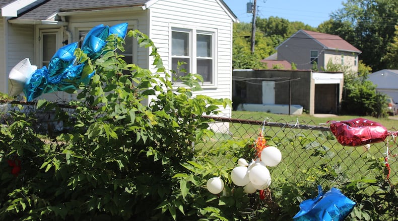 Balloons were hung on the fence outside of the home at 848 Conners St. by family and friends of the two teens who were shot and killed in a detached garage on Aug. 28. The home has since burned down as a resulted of suspected arson. CORNELIUS FROLIK / STAFF