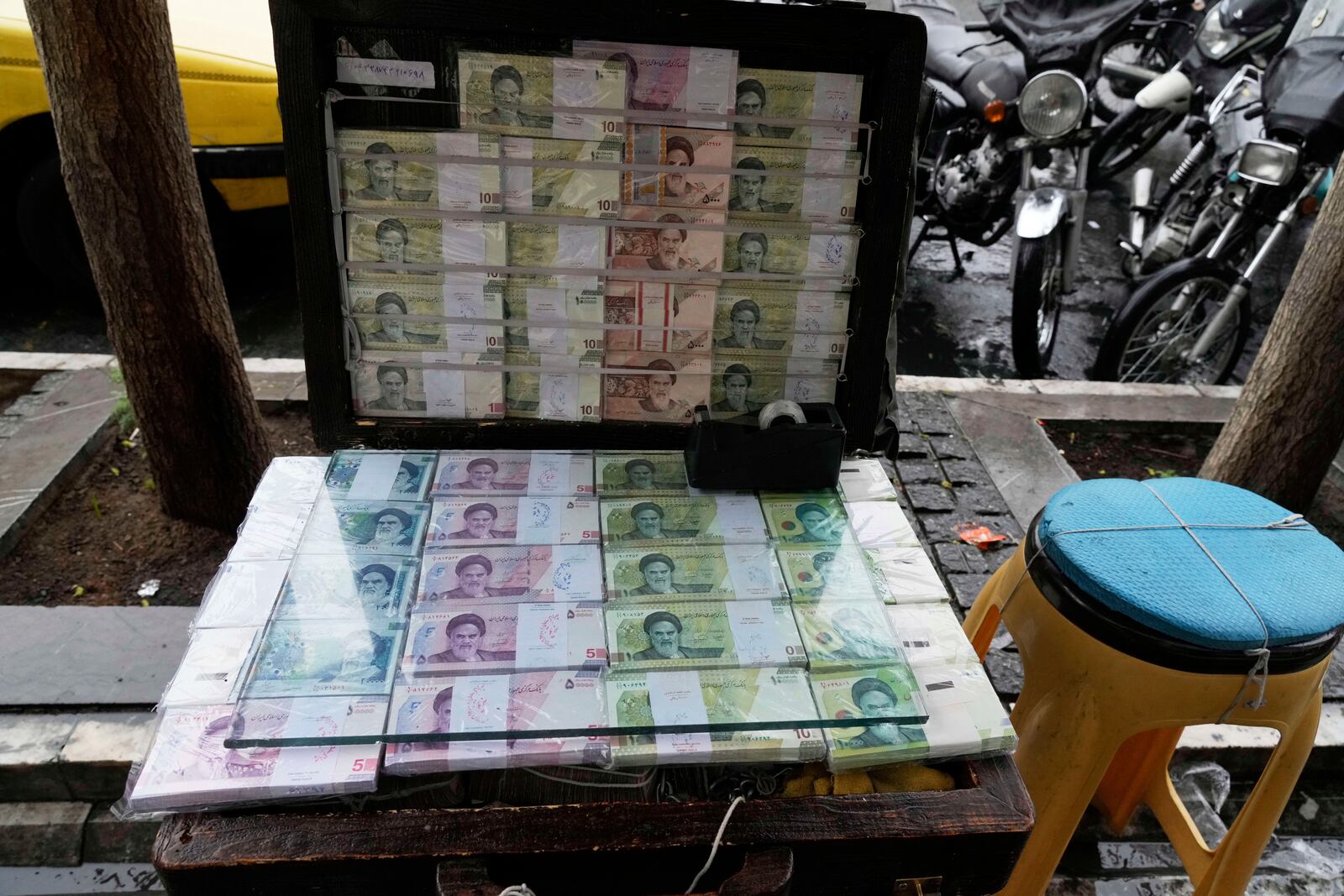 Iranian banknotes are displayed by a street money exchange at Ferdowsi street, Tehran's go-to venue for foreign currency exchange, in downtown Tehran, Iran, Saturday, April 5, 2025. (AP Photo/Vahid Salemi)