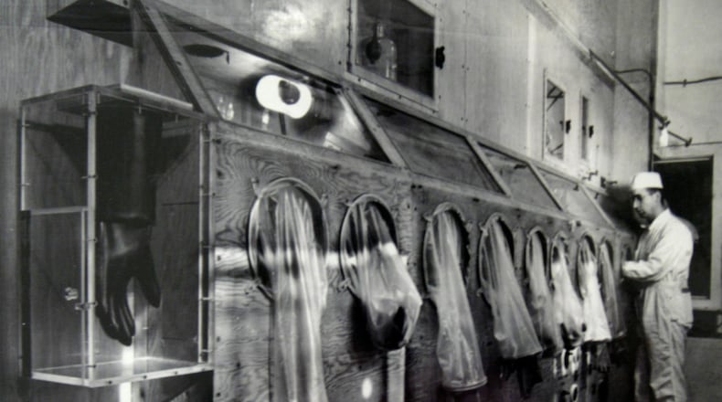 The Mound Museum in Miamisburg houses technology, worker information and photographs of its' history including this photograph taken in 1946 of a worker on the first glove box line processing polonium.  Photo from the Mound Museum archive