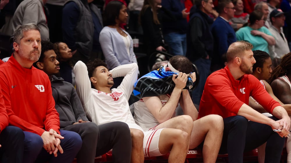 Dayton's Javon Bennett, third from left, and Jacob Conner, right of Bennett, react in the final seconds of a loss to Illinois State in the quarterfinals of the National Invitation Tournament on Wednesday, March 25, 2026, at UD Arena. David Jablonski/Staff