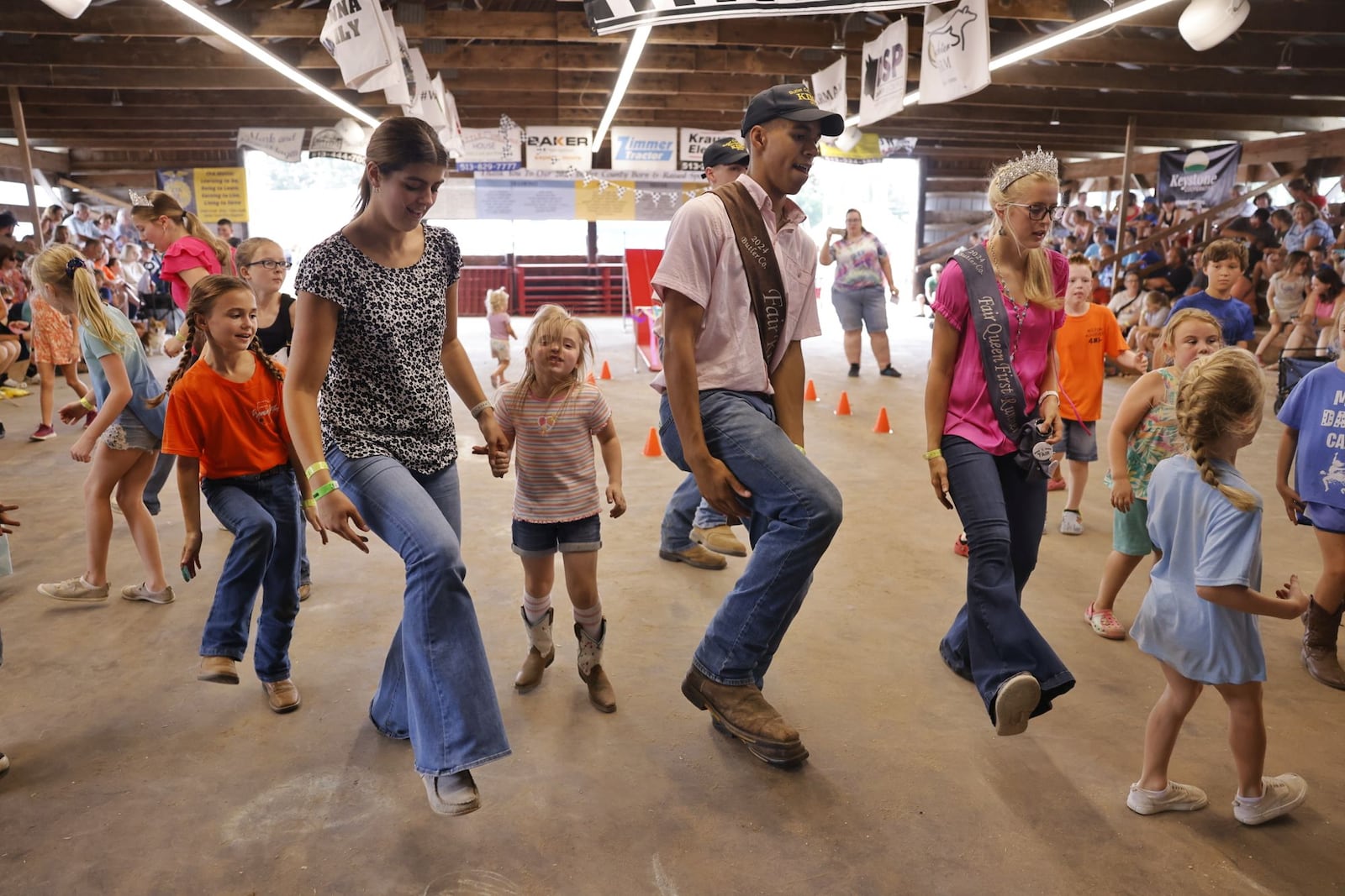 Fair royalty leads line dancing with kids Wednesday, July 24, 2024 at Butler County Fair in Hamilton. NICK GRAHAM/STAFF