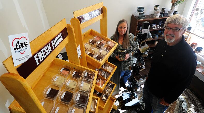 Greg and Lori Zastrow the owners of Love Fudge & Pottery, located in Thrive at Market Square in Miamisburg. MARSHALL GORBY\STAFF