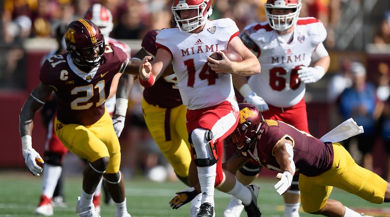 Quarterback Gus Ragland #14 of the Miami RedHawks carries the ball against the Minnesota Golden Gophers during the first quarter of the game on September 15, 2018, at TCF Bank Stadium in Minneapolis, Minnesota. (Photo by Hannah Foslien/Getty Images)