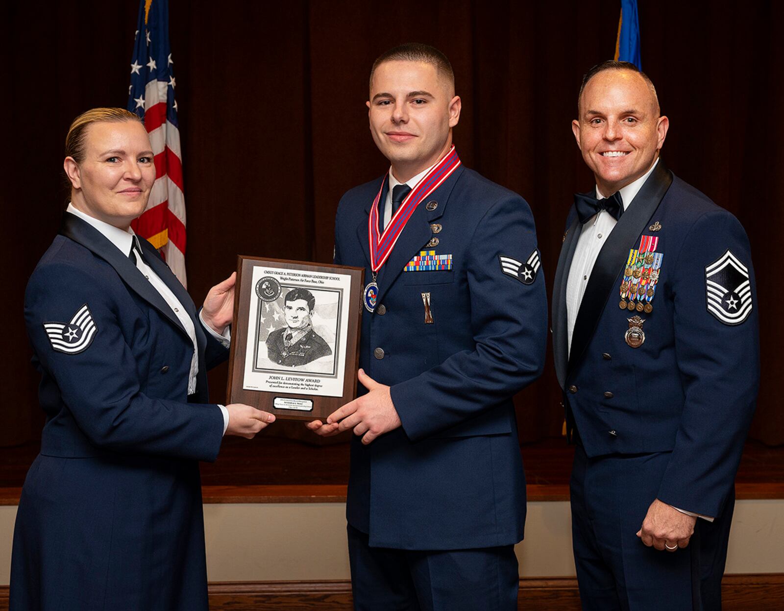 Tech Sgt. Jacquelyn Chapin, Air Force Sergeants Association Kittyhawk Chapter 751 vice president, presents the John L. Levitow Award to Senior Airman Dolton Wood during Airman Leadership School graduation May 5 at the Wright-Patterson Club. The Levitow Award, which goes to the top graduate, is the Air Force’s highest honor for enlisted professional military education and presented to the student who demonstrates the most outstanding leadership and scholastic achievement. U.S. AIR FORCE PHOTO/R.J. ORIEZ