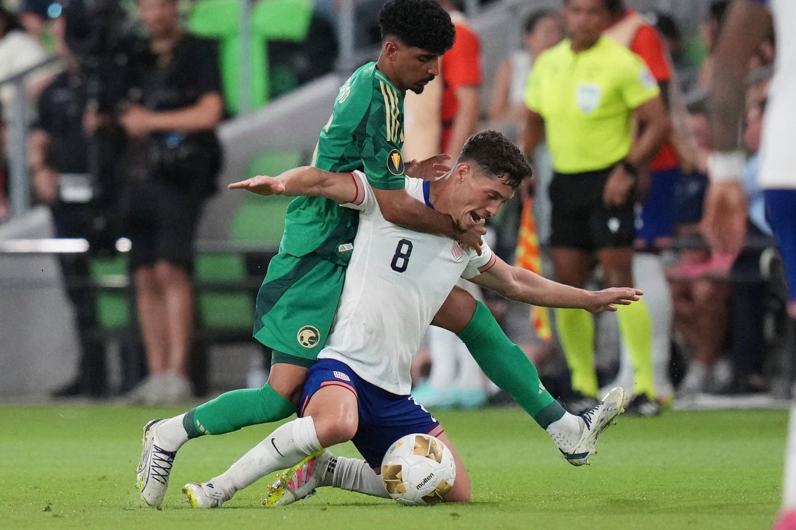 United States' Sebastian Berhalter (8) is grabbed by Saudi Arabia's Ziyad Aljohani, left, during a CONCACAF Gold Cup soccer match, Thursday, June 19, 2025, in Austin, Texas. (AP Photo/Eric Gay)