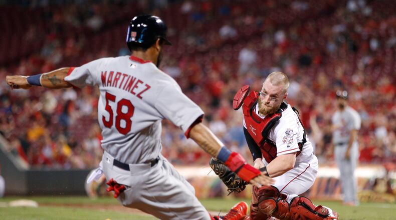 CINCINNATI, OH - SEPTEMBER 21: Jose Martinez #58 of the St. Louis Cardinals slides safely at home plate with a run ahead of the tag attempt by Tucker Barnhart #16 of the Cincinnati Reds in the seventh inning of a game at Great American Ball Park on September 21, 2017 in Cincinnati, Ohio. The Cardinals won 8-5. (Photo by Joe Robbins/Getty Images)