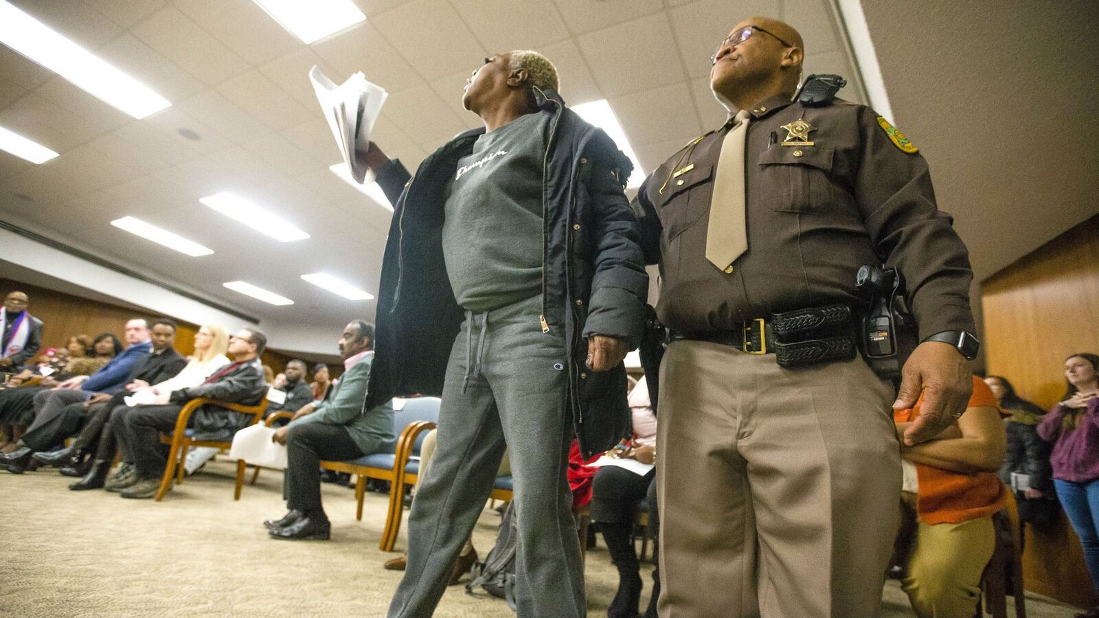 A family member of Eric Logan's is removed from the room Friday, March 6, 2020, during a news conference on his shooting death in South Bend, Ind. A special prosecutor announced that former Officer Ryan O'Neill has been cleared in the shooting. (Michael Caterina/South Bend Tribune via AP)