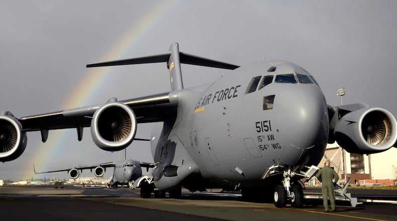 Staff Sgt. John Eller conducts pre-flights check on his C-17 Globemaster III Jan. 3 prior to taking off from Hickam Air Force Base, Hawaii for a local area training mission. Sgt. Eller is a loadmaster from the 535th Airlift Squadron. (U.S. Air Force photo/Tech. Sgt. Shane A. Cuomo)