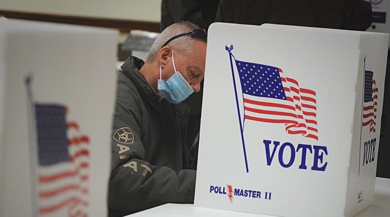 Voting at the Belmont Church of Christ in Dayton Tuesday morning. MARSHALL GORBY\STAFF
