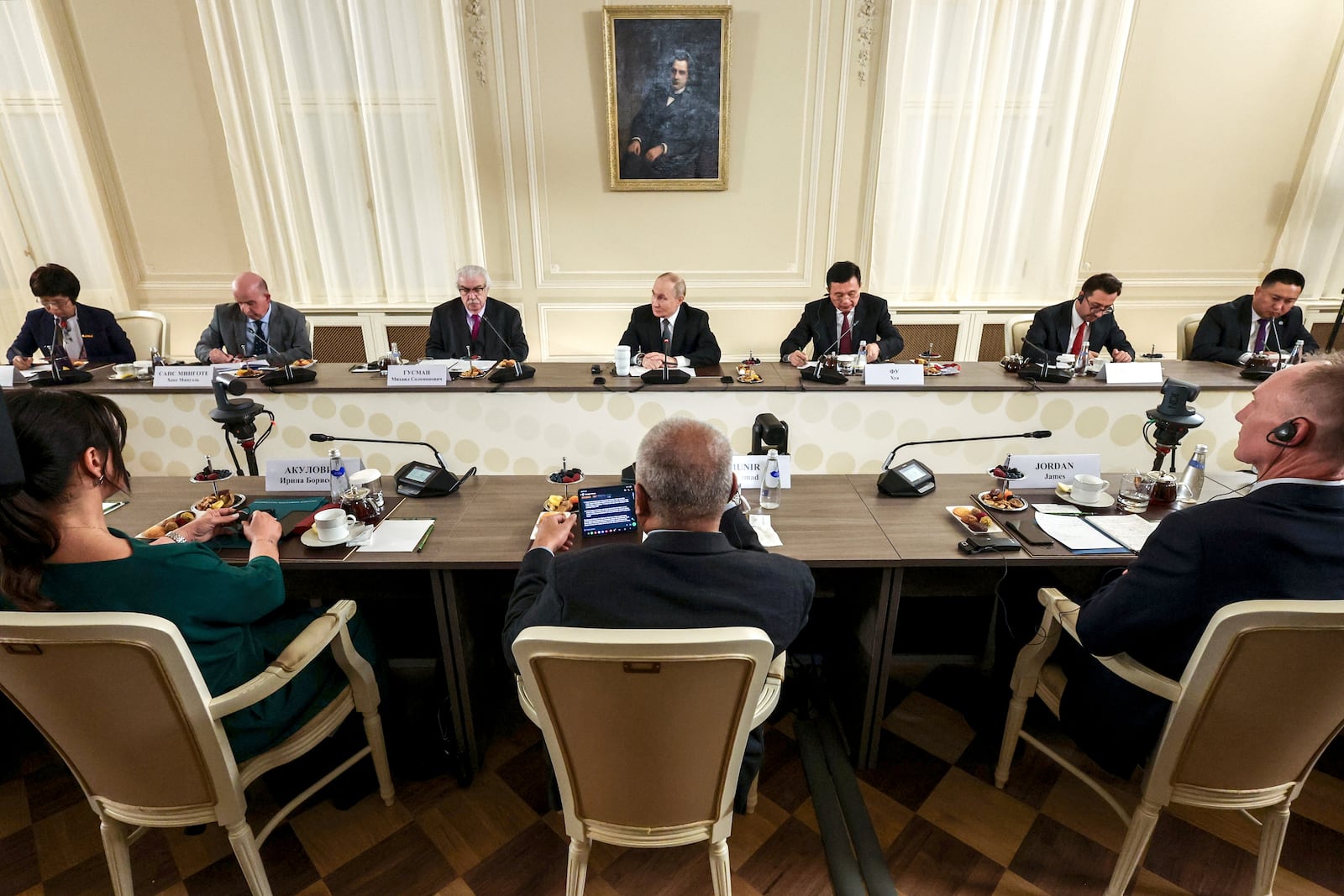 Russian President Vladimir Putin, center, meets with the heads of international news agencies at the newly renovated St. Petersburg Rimsky-Korsakov State Conservatory on the sidelines of the St. Petersburg International Economic Forum in St. Petersburg, Russia, Wednesday, June 18, 2025. (Vyacheslav Prokofyev, Sputnik, Kremlin Pool Photo via AP)