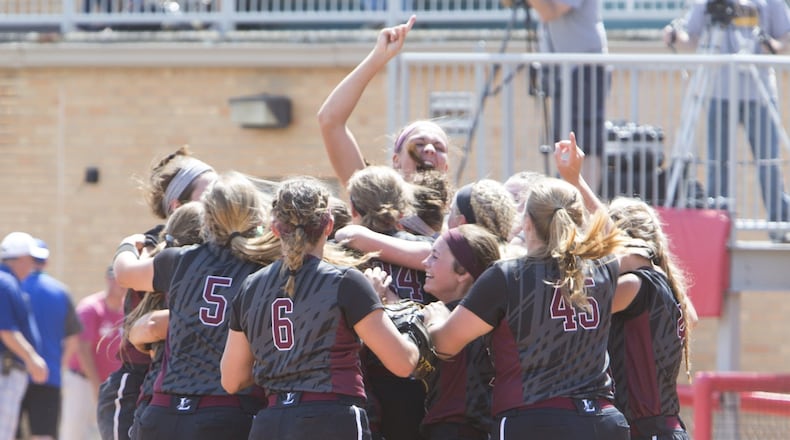 Lebanon’s softball players celebrate after beating North Canton Hoover 8-6 in a Division I state semifinal Thursday at Firestone Stadium in Akron. ROBERT ROSSITER/THE CANTON REPOSITORY
