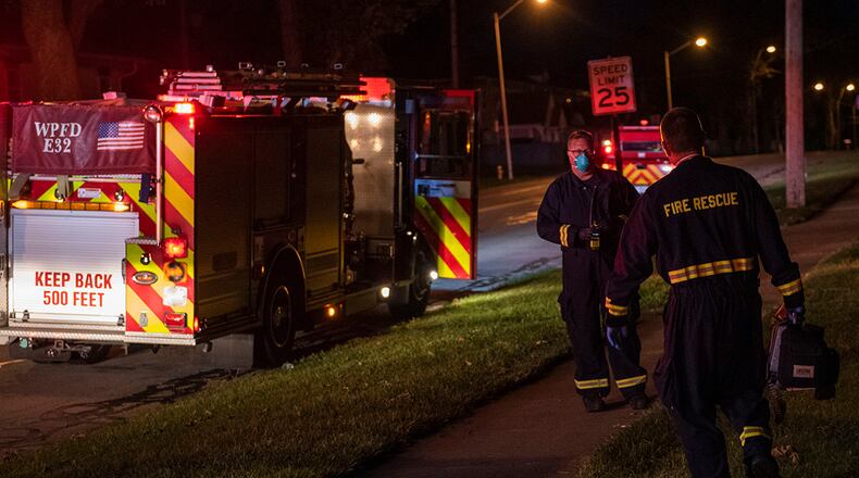 Firefighters return to their truck after responding to a call for medical assistance in base housing June 23 at Wright-Patterson Air Force Base. The 788th Civil Engineer Squadron Fire Department has three stations strategically located around base to ensure a response time of five minutes or less. U.S. AIR FORCE PHOTO/WESLEY FARNSWORTH
