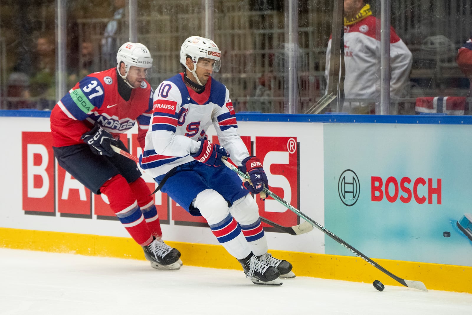 USA's Matty Beniers, right, and Norway's Markus Vikingstad, left, challenge for the puck during the group B match between USA and Norway at the IIHF Ice Hockey World Championships in Herning, Denmark, Wednesday, May 14, 2025. (Bo Amstrup/Ritzau Scanpix via AP)