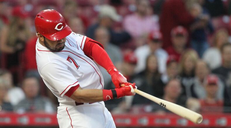 The Reds’ Eugenio Suarez doubles and drives in two runs against the Brewers on Monday, April 30, 2018, at Great American Ball Park in Cincinnati. David Jablonski/Staff