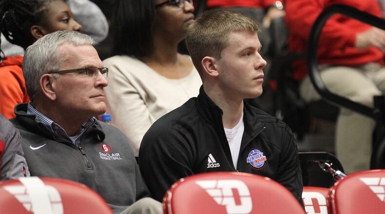 Sean McNeil, center, watches from behind the Dayton bench during a game against Mississippi State on Nov. 30, 2018, at UD Arena.