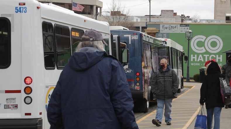 Riders get on and off the SCAT buses earlier this year at the bus center in downtown Springfield. BILL LACKEY/STAFF