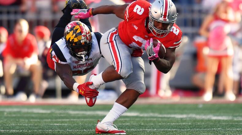 Antoine Brooks #25 of the Maryland Terrapins hangs on to make the tackle on J.K. Dobbins #2 of the Ohio State Buckeyes in the second quarter after a run at Ohio Stadium on October 7, 2017 in Columbus, Ohio. (Photo by Jamie Sabau/Getty Images)