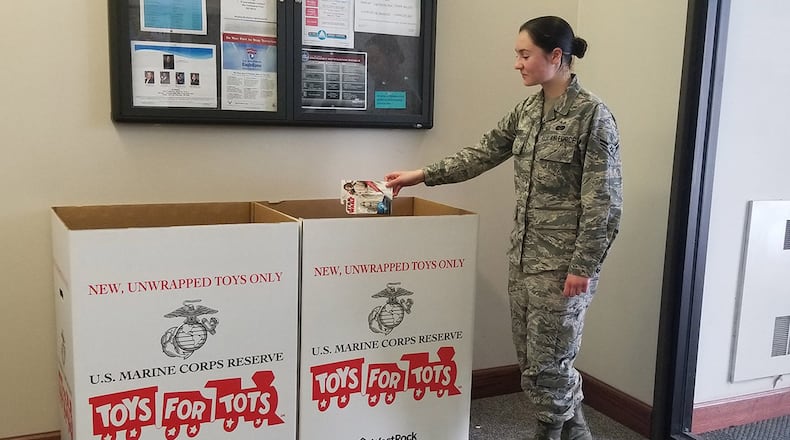 Airman 1st Class Haley Wright, a paralegal in the 88th Air Base Wing’s Judge Advocate office, donates a toy for the 2019 Marine Corps Toys for Tots campaign at Wright-Patterson Air Force Base. New, unwrapped toys may be donated until Dec. 13. (U.S. Air Force photo/Pamela Piccoli)