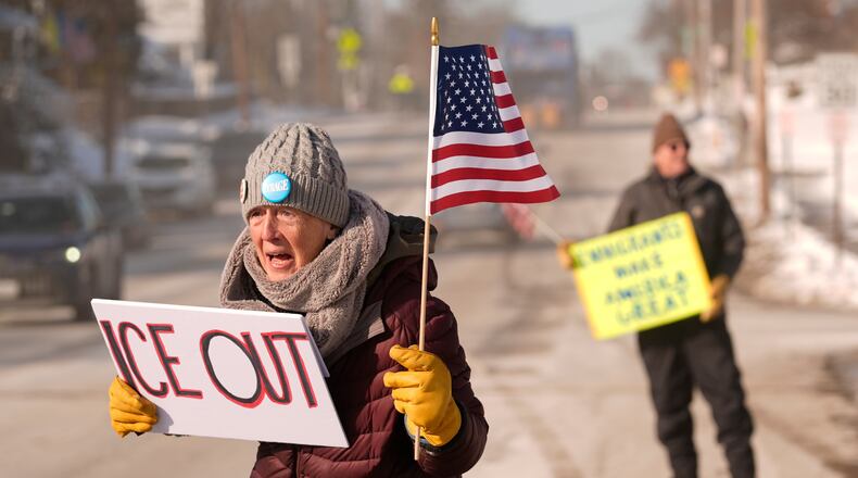 Rosie Grutze protests the presence of the U.S. Immigration and Customs Enforcement, Wednesday, Jan. 21, 2026, in Portland, Maine. (AP Photo/Robert F. Bukaty)