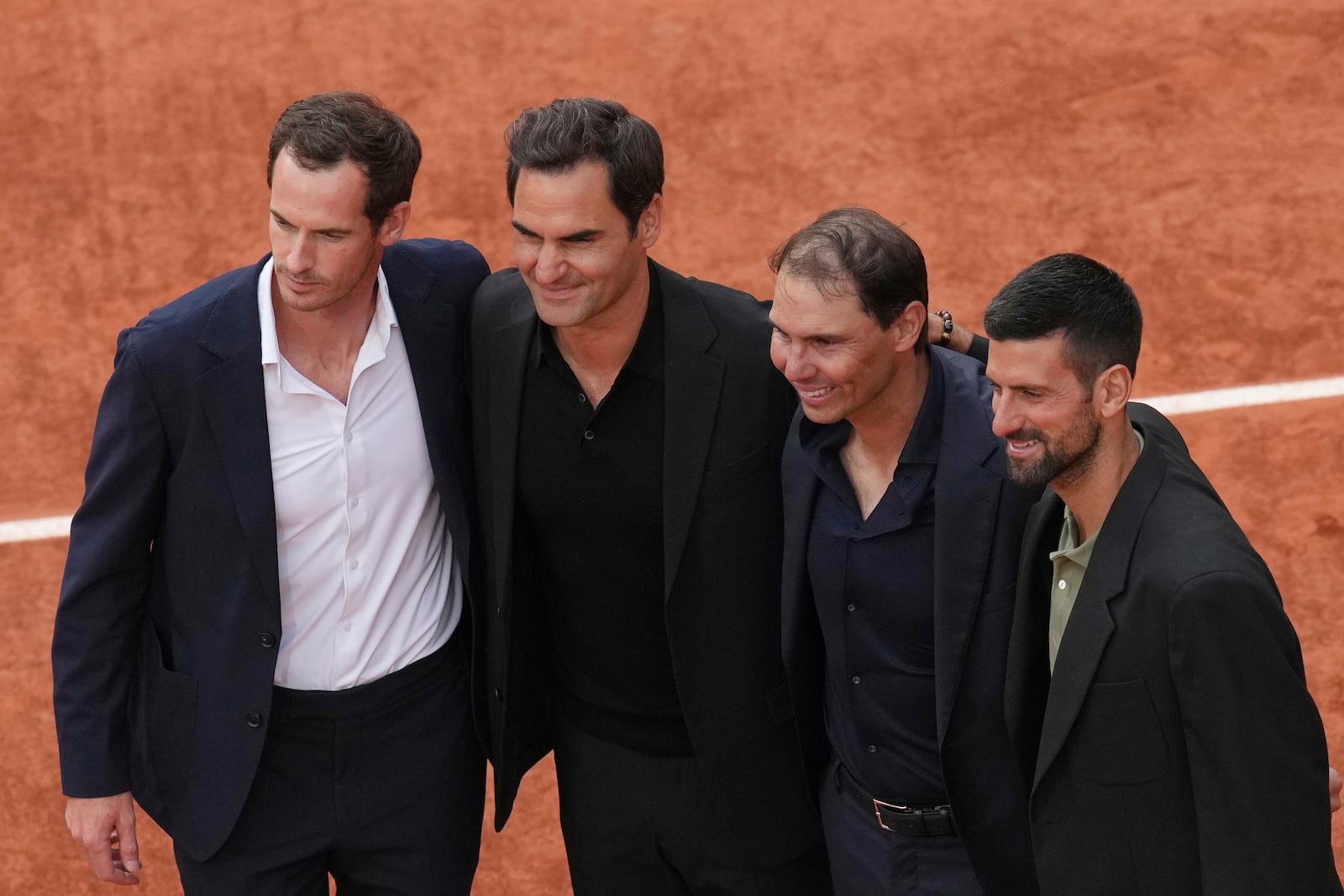 Rafa Nadal, second right, poses with, from left, Andy Murray, Roger Federer and Novak Djokovic, right, during a farewell ceremony at center court Philippe-Chatrier, at the Roland-Garros stadium, in Paris, Sunday May 25, 2025. (AP Photo/Christophe Ena)