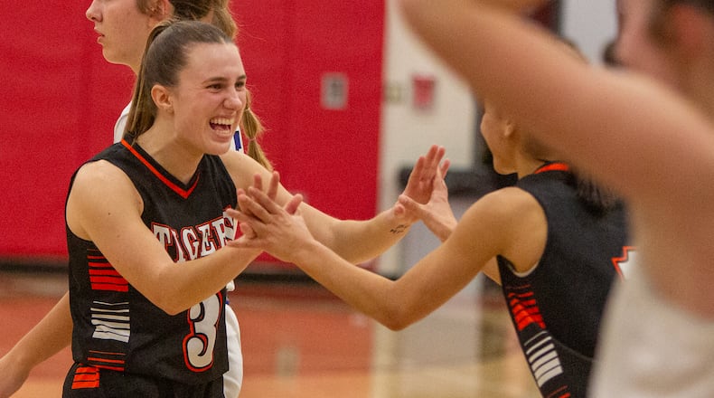 West Liberty-Salem's Megan Hollar celebrates with teammate Lilly Weaver after Friday's victory over Miami East in a Division III tournament game at Northridge High School. Jeff Gilbert/CONTRIBUTED