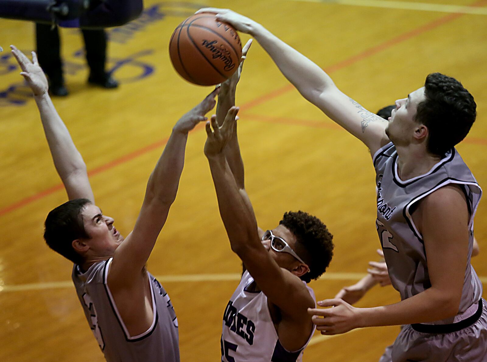 Fairmont’s Cade Morgan (3) and Dylan Crutchfield (22) defend Middletown center Jawunn Bailey during Wednesday night’s game at Wade E. Miller Gym in Middletown. CONTRIBUTED PHOTO BY E.L. HUBBARD