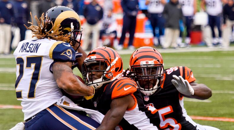 Cincinnati Bengals cornerback Dre Kirkpatrick helped by teammate Wallace Gilberry tackles St. Louis running back Tre Mason during their 31-7 win over the Rams Sunday, Nov. 29, 2015, at Paul Brown Stadium in Cincinnati. NICK GRAHAM/STAFF