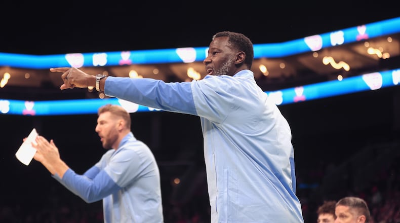 Dayton's Anthony Grant, front, and Sean Damaska, back, coach during a game against Virginia on Saturday, Dec. 6, 2025, at the Spectrum Center in Charlotte, N.C. David Jablonski/Staff