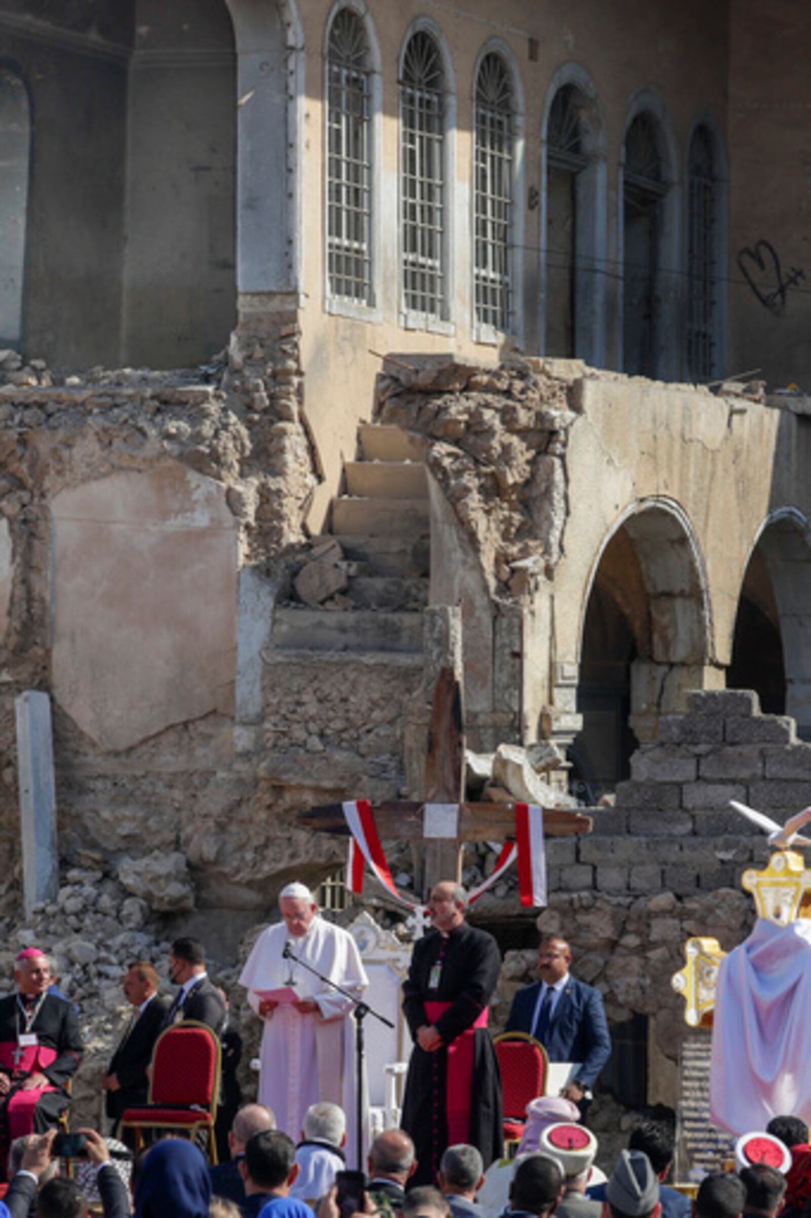 FILE - Pope Francis, surrounded by shells of destroyed churches, leads a prayer for the victims of war at Hosh al-Bieaa Church Square, in Mosul, Iraq, once the de-facto capital of IS, Sunday, March 7, 2021. (AP Photo/Andrew Medichini, file)