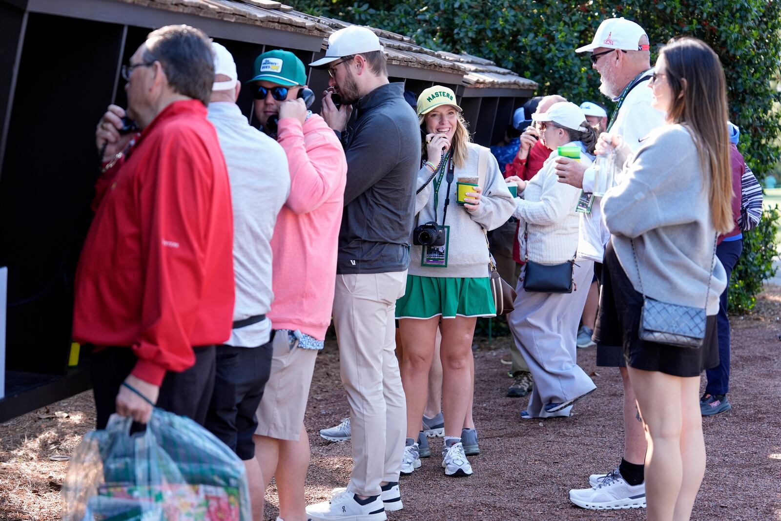 Patrons line up to use courtesy phones during a practice around at the Masters golf tournament, Wednesday, April 9, 2025, in Augusta, Ga. (AP Photo/Ashley Landis)