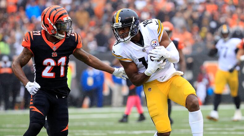 CINCINNATI, OH - OCTOBER 14: Darqueze Dennard #21 of the Cincinnati Bengals attempts to tackle JuJu Smith-Schuster #19 of the Pittsburgh Steelers during the first quarter at Paul Brown Stadium on October 14, 2018 in Cincinnati, Ohio. (Photo by Andy Lyons/Getty Images)