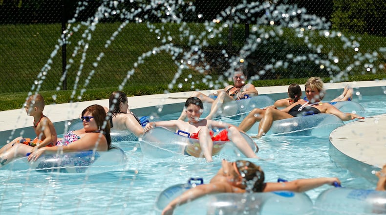 Swimmers at the Kroger Aquatics Center at The Heights float around the Lazy River on a warm Tuesday afternoon. The parking lot of the water park was almost full by noon.
