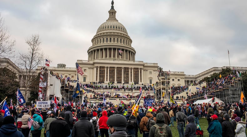 FILE - Members of a pro-Trump mob storm the Capitol in Washington, Jan. 6, 2021. What appeared to be racial progress in rural Virginia turned into bitter conflict over a Confederate statue, the election and the Capitol riot. Now, people there foresee “a very dangerous time.” (Jason Andrew/The New York Times)