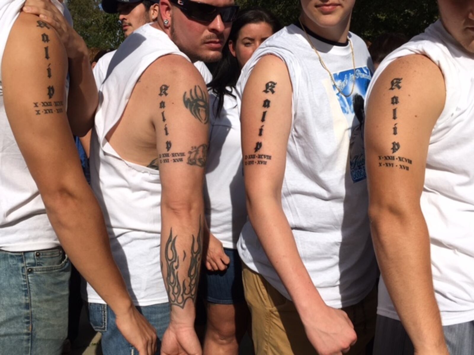 Friends of Kalip Grimm show off new tattoos remembering the Miaimisburg graduate killed in a wrong-way crash Monday. Sean Cudahy/Staff