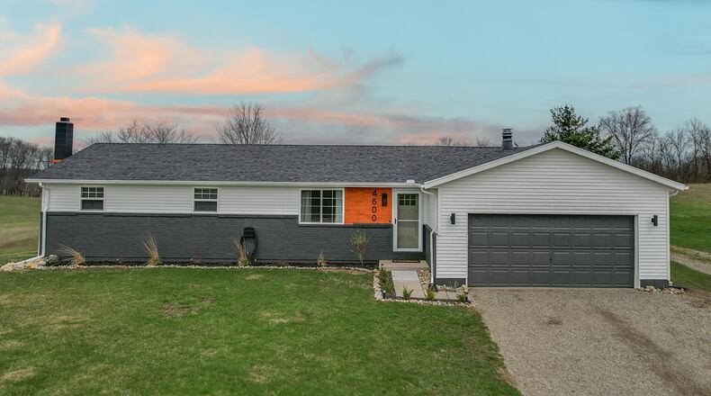 The home features a two-car attached garage (with opener), freshly painted brick and an asphalt driveway. Contributed photos