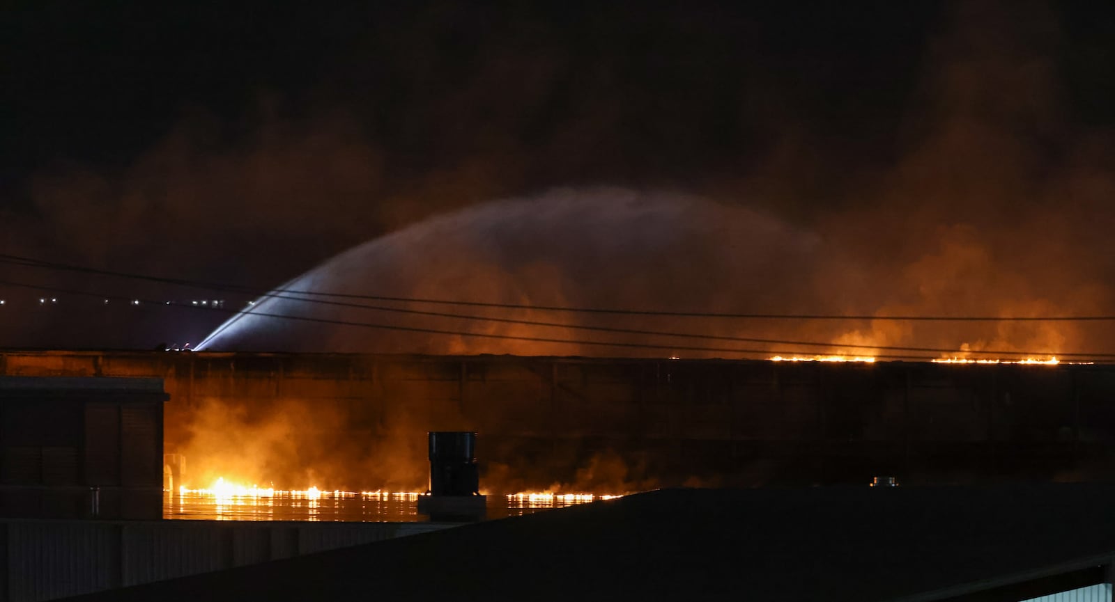 Area firefighters worked to pour water on flames at the Fuyao Glass America plant fire Sunday, March 22, 2026 in Moraine. BRYANT BILLING / STAFF