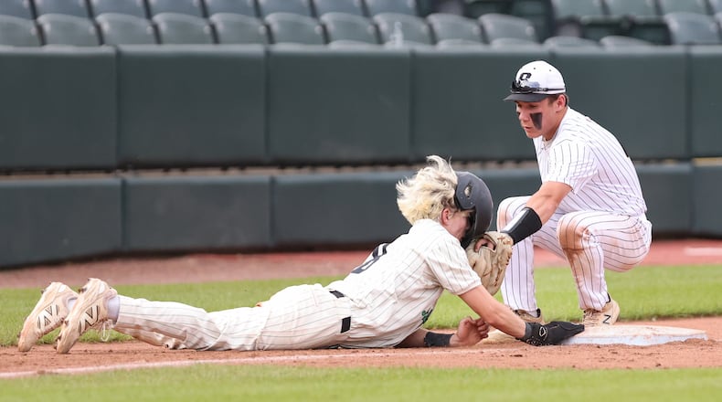 Northmont's Garret Hoke slides back into third base as Sidney senior shortstop Eli McKenzie tries to tag him during a nonconference game earlier this season at Day Air Ball Park. BRYANT BILLING / STAFF