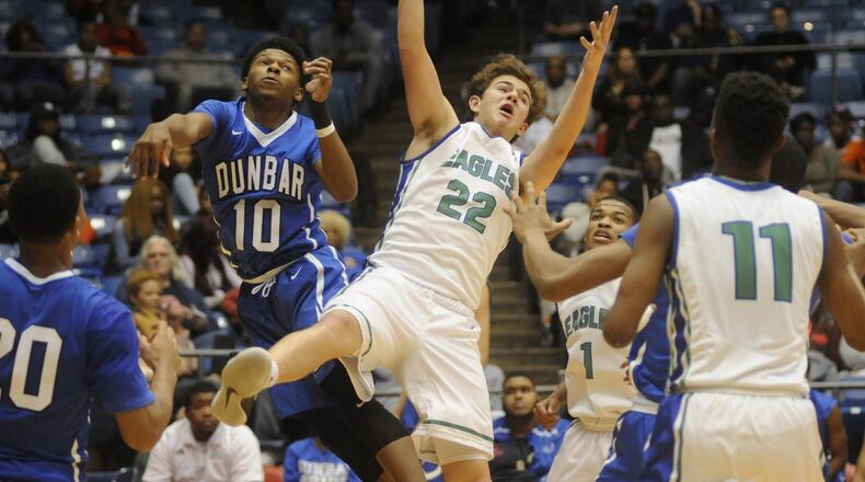 Dunbar’s Brenten Strange (10) and CJ’s Nick Barnes. Dunbar defeated CJ 76-69 in a boys high school basketball D-II sectional final at UD Arena on Saturday, March 4, 2017. MARC PENDLETON / STAFF