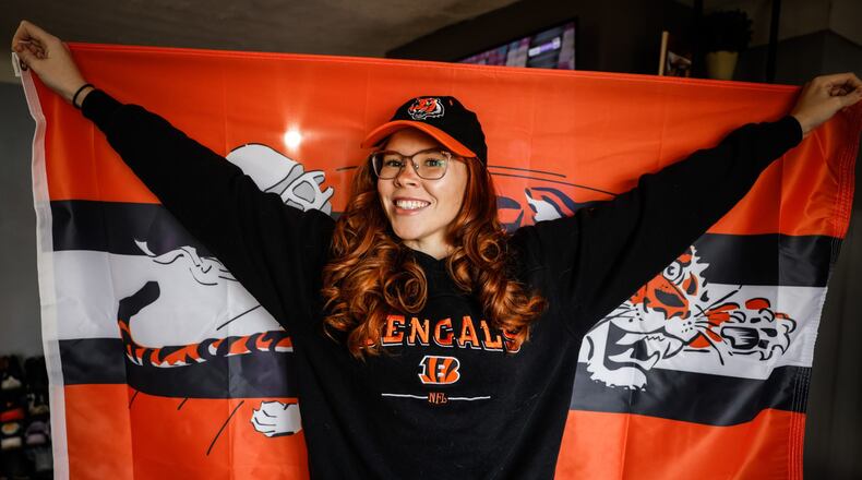 Cincinnati Bengals fan extraordinaire Alexandra Farmer wears a sweatshirt once worn by her Bengals-fan great grandmother, a shirt she wears each Sunday in her memory while rooting on the team. Farmer said she is optimistic about the team beating the Las Vegas Raiders in Wild Card Round of the AFC playoffs. JIM NOELKER/STAFF